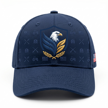 A premium navy blue baseball cap displaying a detailed patriotic bald eagle crest on the front with subtle embossed farm tractors, barns, and American flags patterns, isolated on a white background