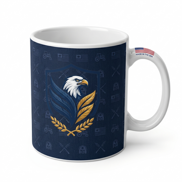 An 11oz white ceramic coffee mug wrapped in a navy blue textured design featuring a central bald eagle shield logo, a subtle farm and military pattern, and a small "MADE IN THE USA" flag icon on the handle
