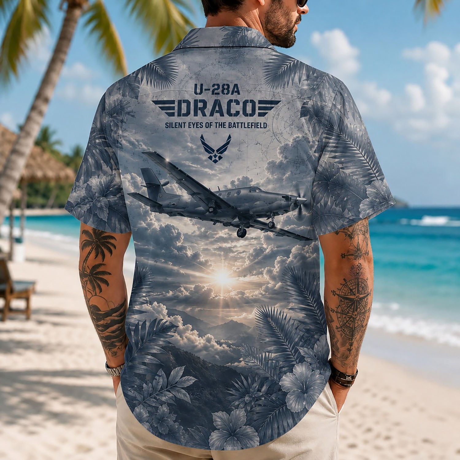 Back view lifestyle of a man showing the Air Force flight wings, dramatic mountain sunburst scenery print, and premium slate blue foliage borders