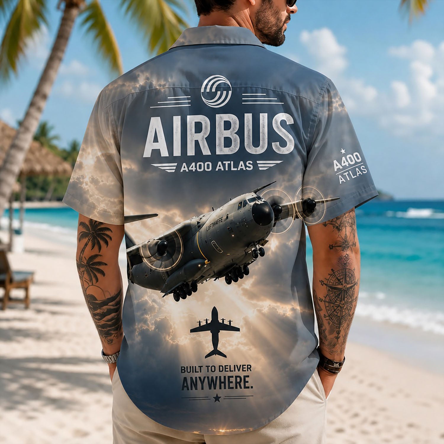 Back view lifestyle of a man showcasing the bold A400M Atlas cargo jet graphics, silhouette icon, and corporate branding on sand