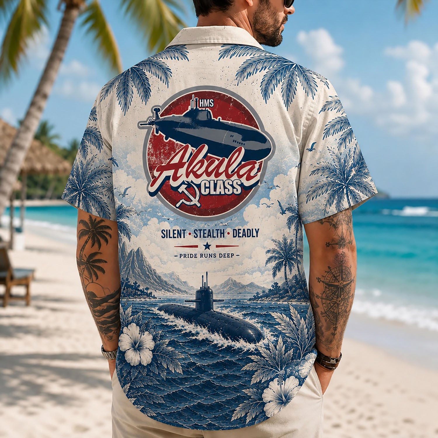 Back view lifestyle of a man walking on a tropical beach wearing the Akula Class Submarine custom veteran shirt showing the detailed large emblem print