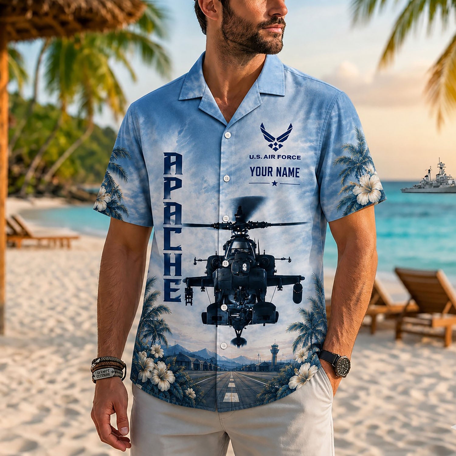 Close-up front lifestyle view of a man wearing the personalized custom name AH-64 Apache aviation shirt on a sunny beach resort