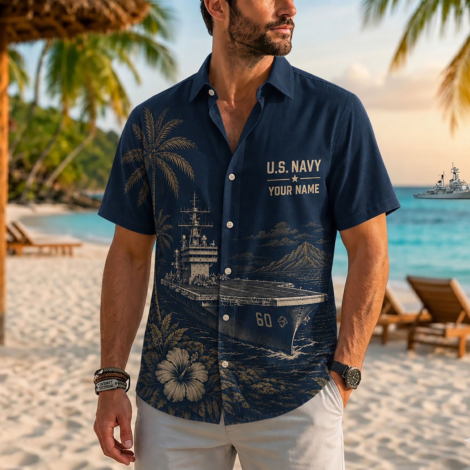 Close-up front view of a male model on a tropical beach wearing the personalized navy blue USS Saratoga CV-60 supercarrier shirt