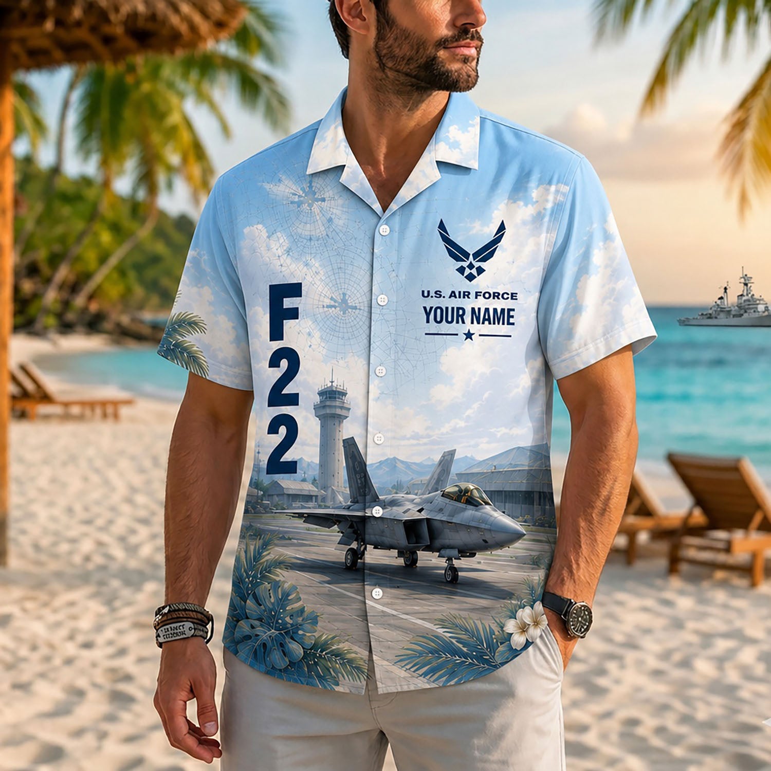 Close-up front lifestyle view of a man on a tropical beach resort modeling the personalized custom name F-22 tactical aviation shirt