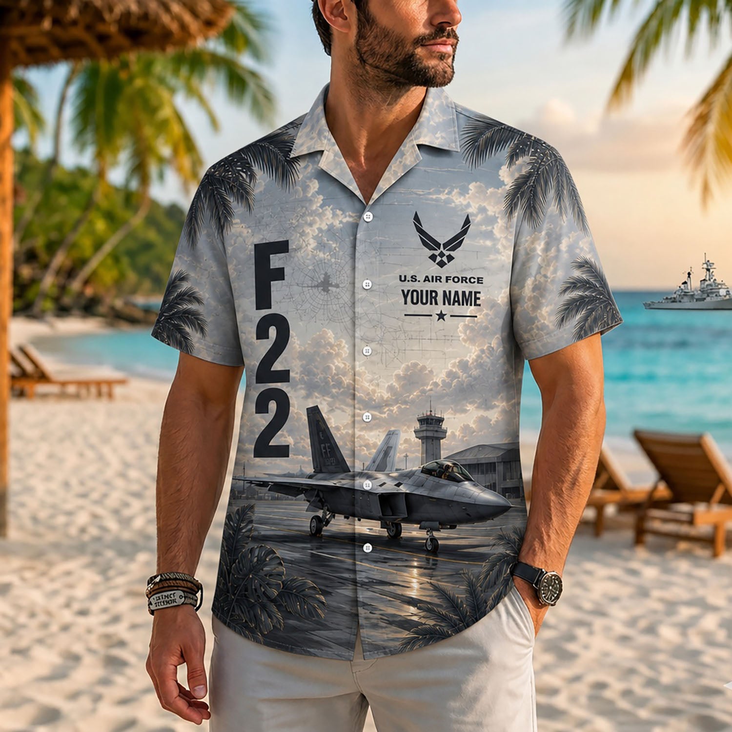 Close-up front lifestyle view of a man on a tropical beach resort wearing the personalized custom name F-22 Raptor military aviation shirt