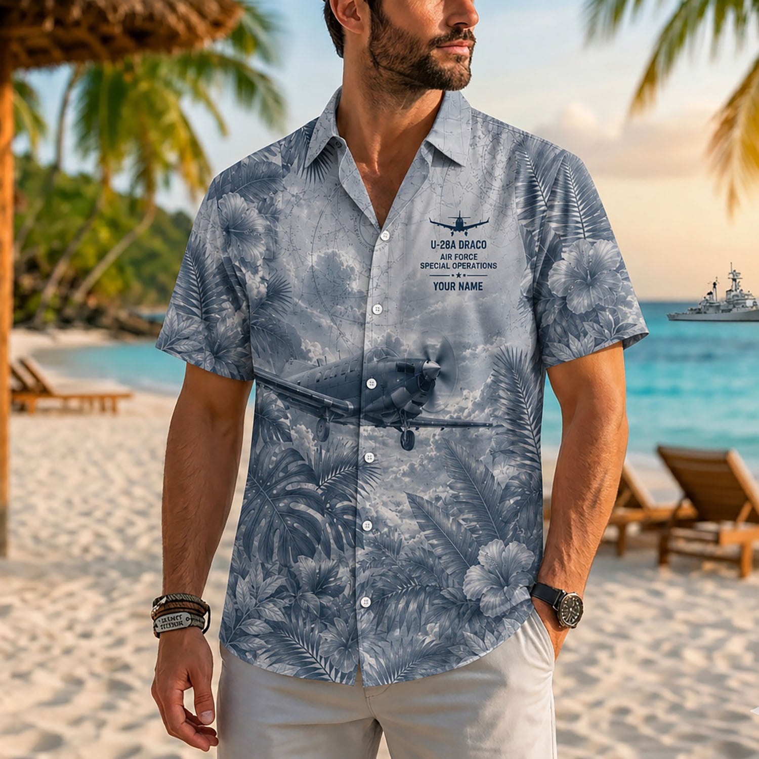 Close-up front lifestyle view of a male model on a sunny tropical beach wearing the personalized U-28A Draco special ops aviation shirt