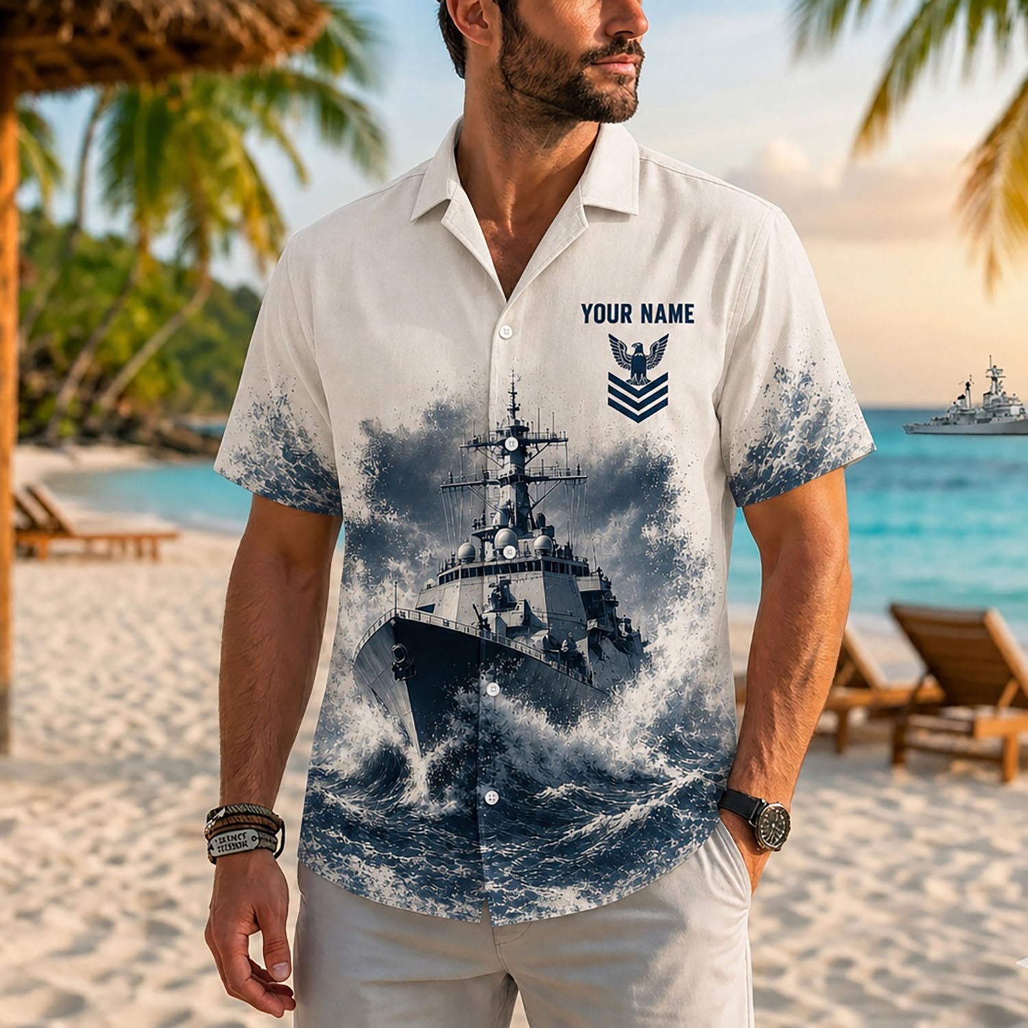 Close-up front view of a male model on a beach resort wearing the personalized cream and navy blue Surface Warfare military shirt