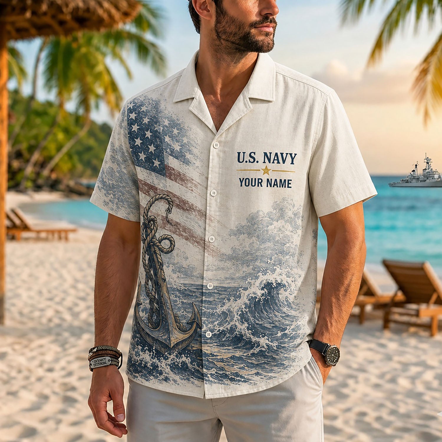 Close-up front view of a male model on a tropical beach wearing the personalized cream US Navy anchor and American flag resort shirt