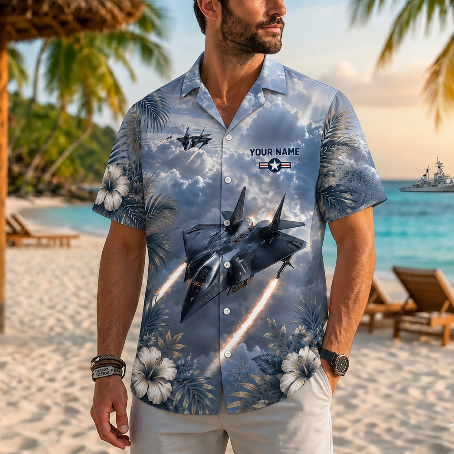 Close-up front view of a male model on a beach wearing the dramatic dark-toned F14 fighter jet military Hawaiian shirt