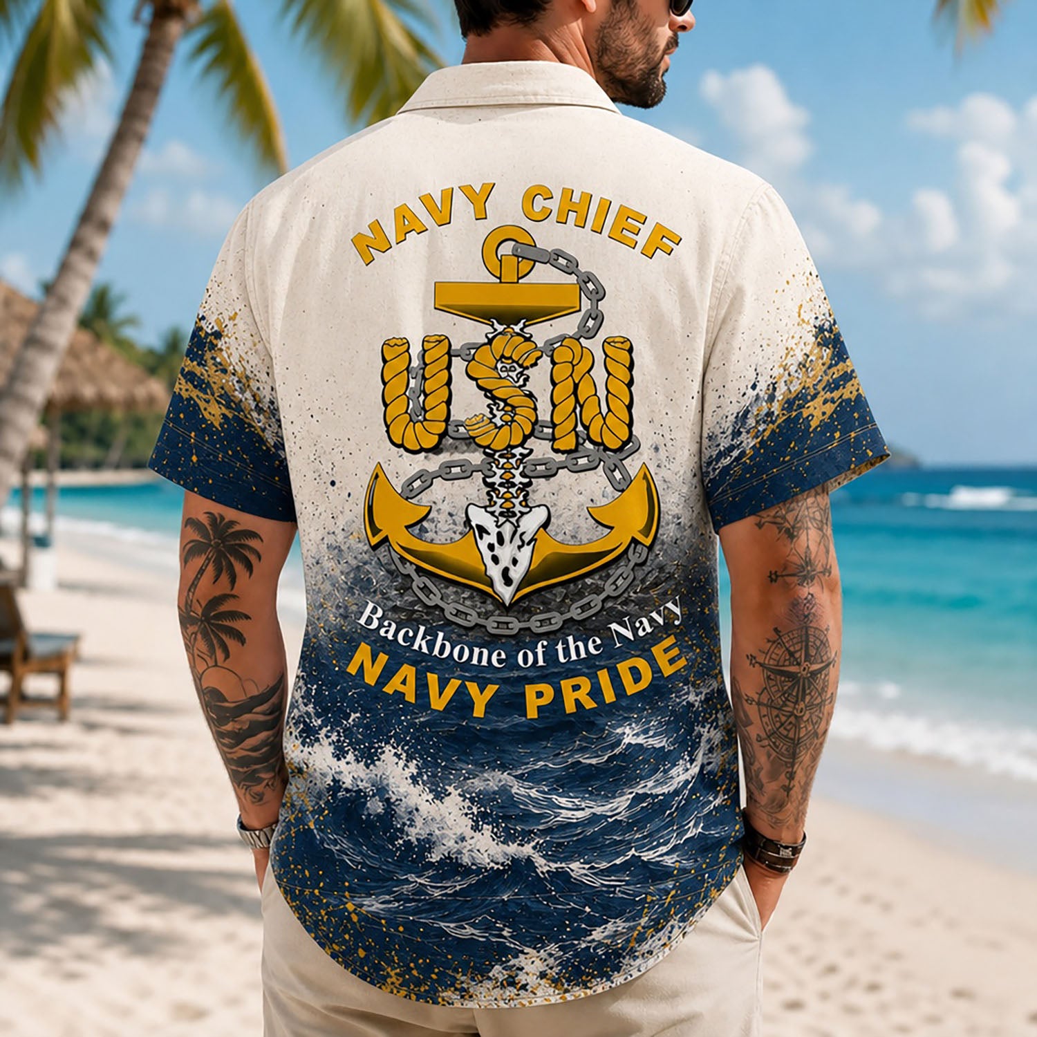 Back view lifestyle of a man showing the heavy navy and gold paint splatter effects and large CPO anchor print by the seashore