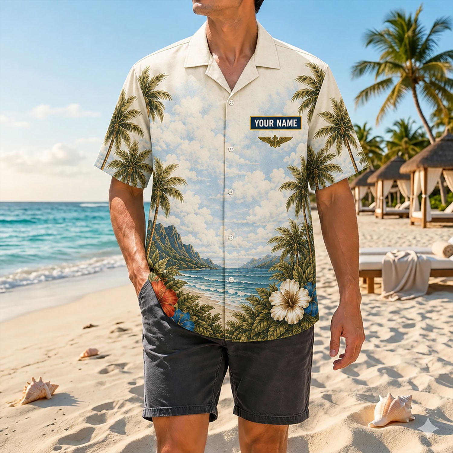 Full shot of a male model posing by the ocean resorts wearing the custom name USN Corpsman shirt paired with charcoal casual shorts