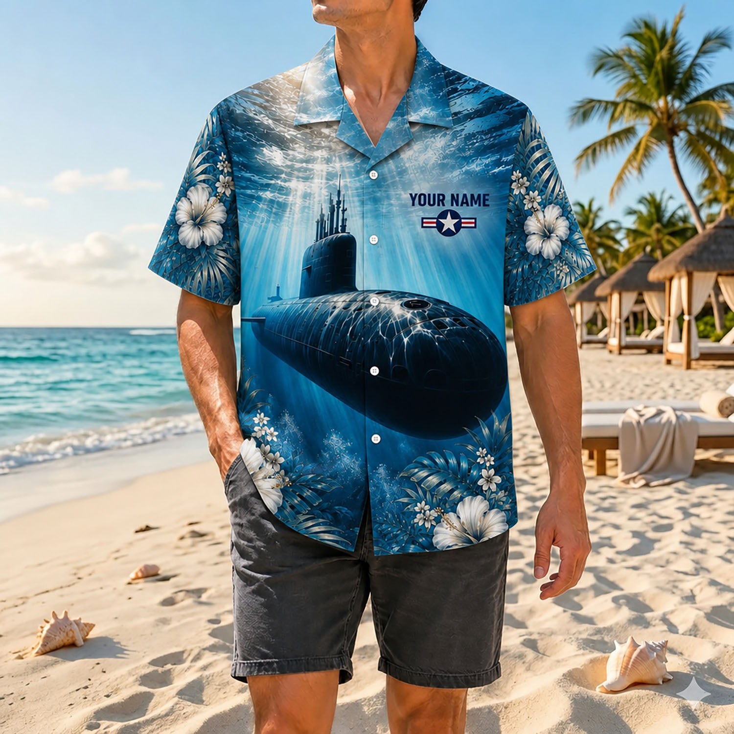 Full shot of a male model posing by the ocean wearing the custom silent strength submarine navy shirt with gray shorts