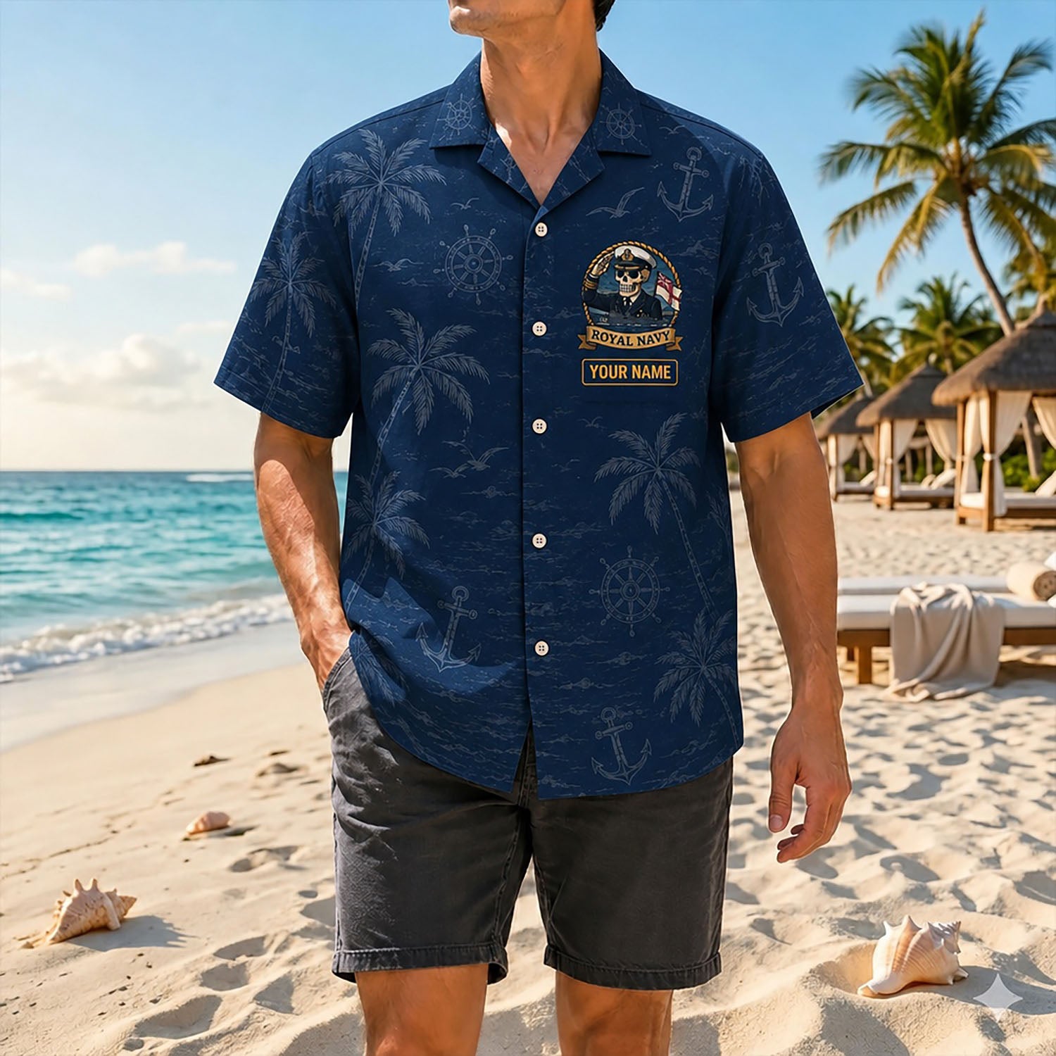 Full shot of a male model posing on a sunny shore wearing the custom Royal Navy Veteran Hawaiian shirt with dark gray shorts