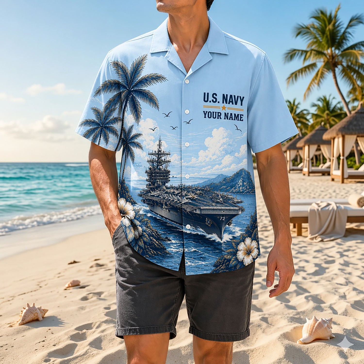 Full shot of a male model posing on a sunny shore wearing the personalized US Navy CVN-72 aircraft carrier tropical shirt paired with dark gray shorts