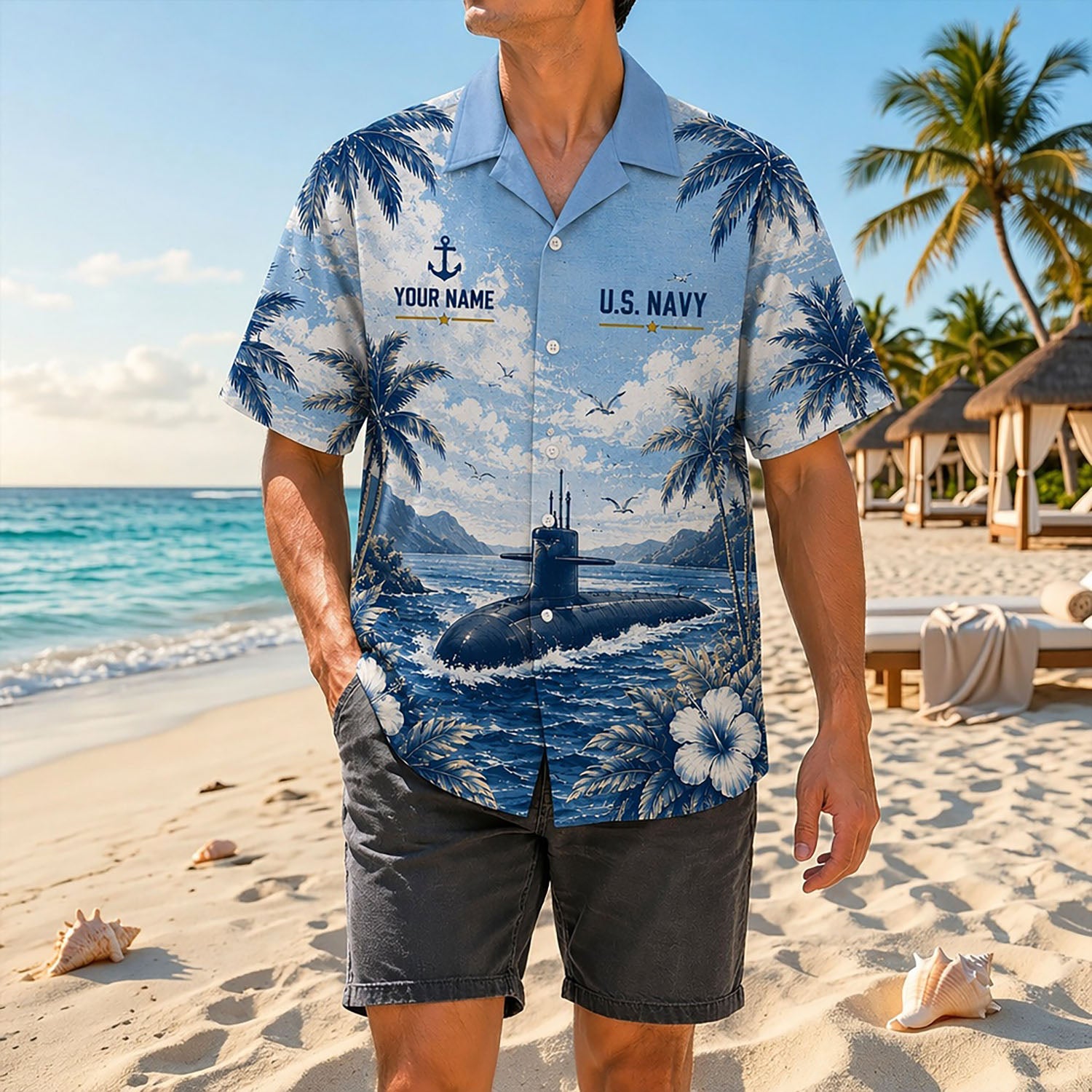 Full shot of a male model posing on a sunny shore wearing the personalized US Navy LHD-1 assault ship tropical shirt paired with dark gray shorts