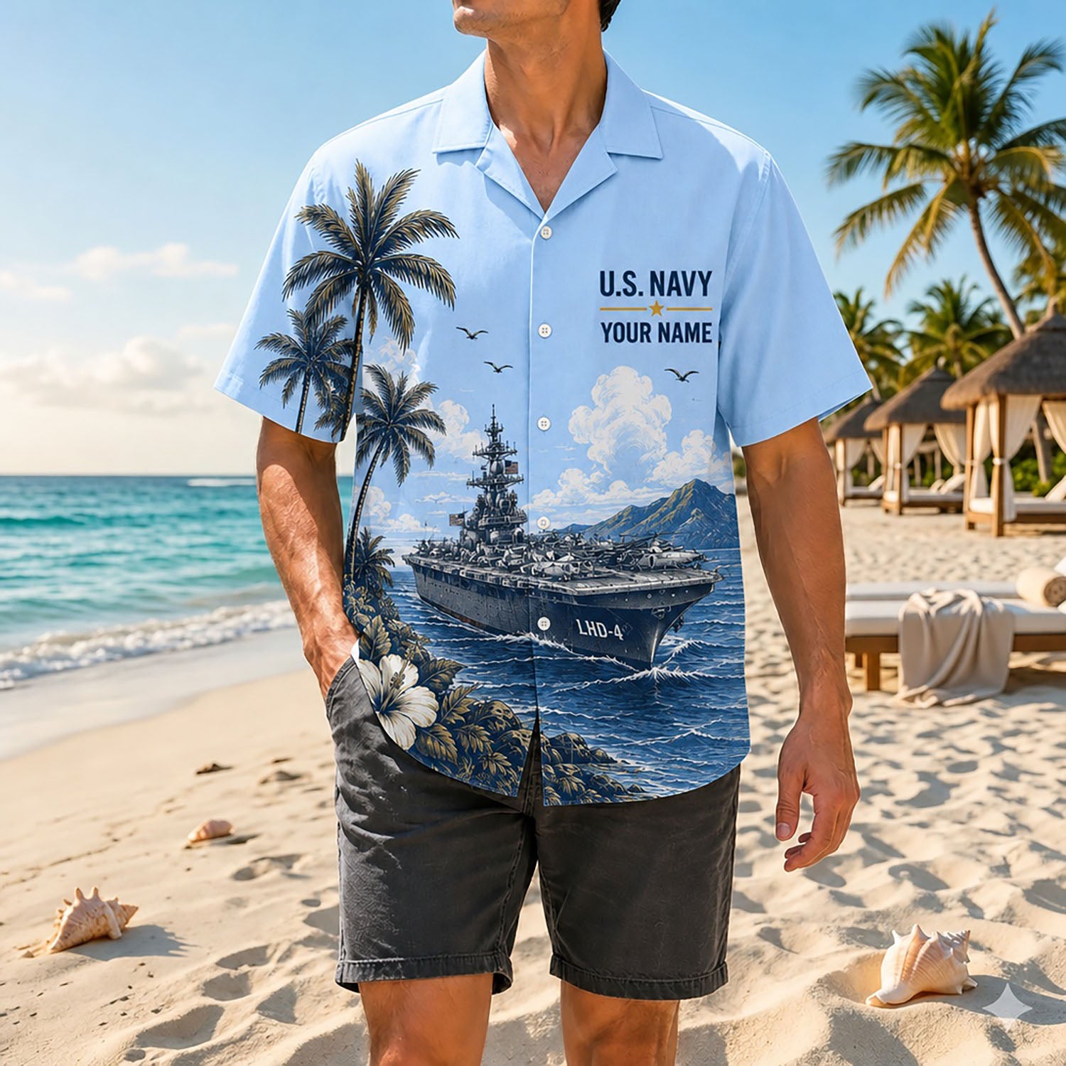 Full-body beach lifestyle image of a man wearing the personalized US Navy USS Boxer LHD-4 tropical shirt combined with charcoal shorts