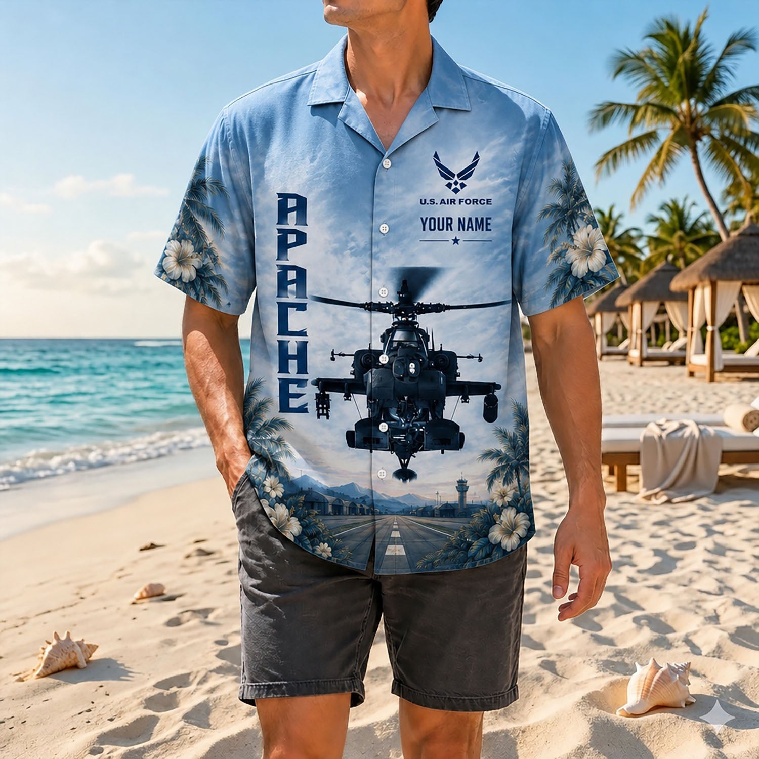 Full-body shot of a man modeling the custom military attack helicopter shirt on a sandy shore paired with dark grey shorts