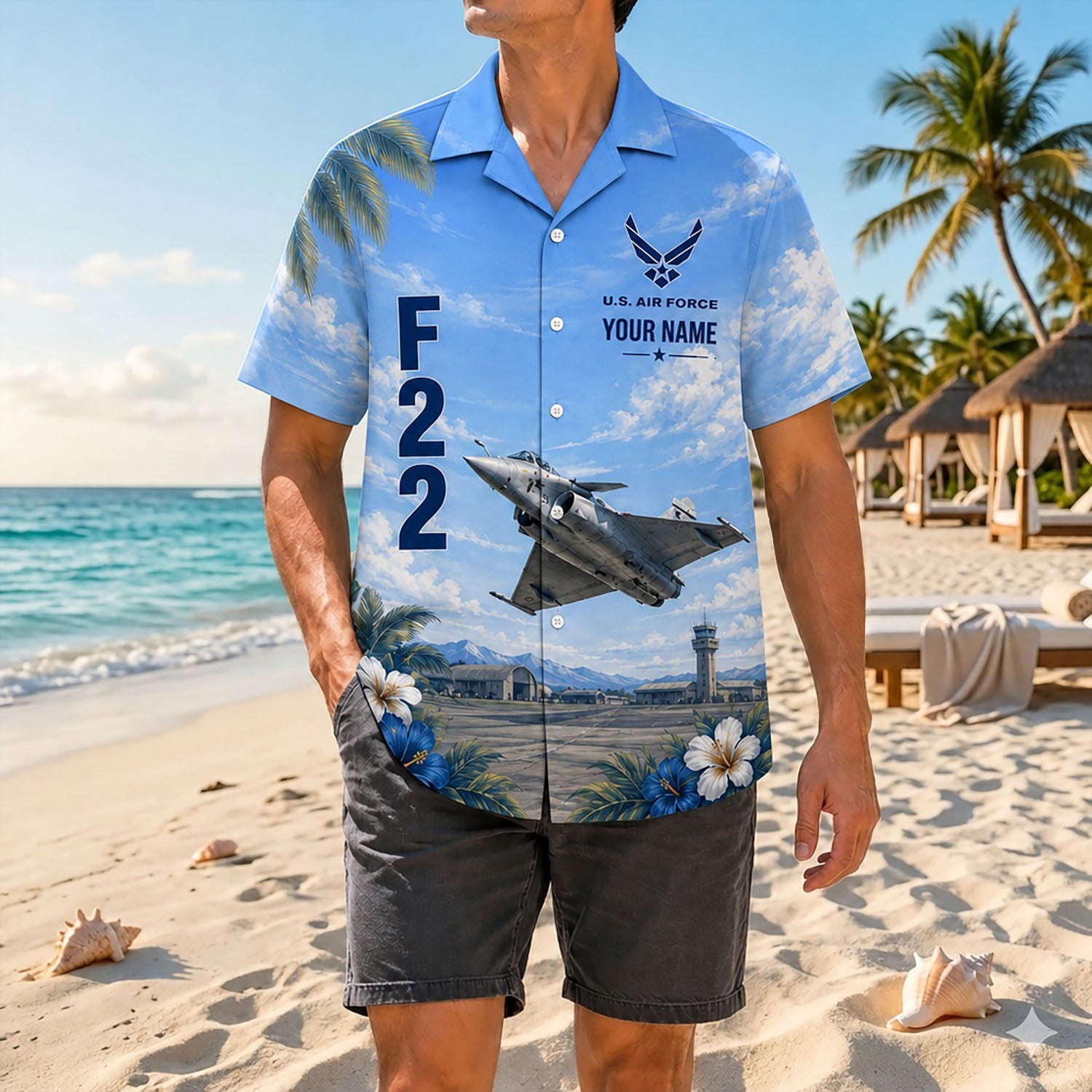 Full-body shot of a man modeling the custom name fighter jet holiday shirt on a sandy shore with casual dark grey shorts