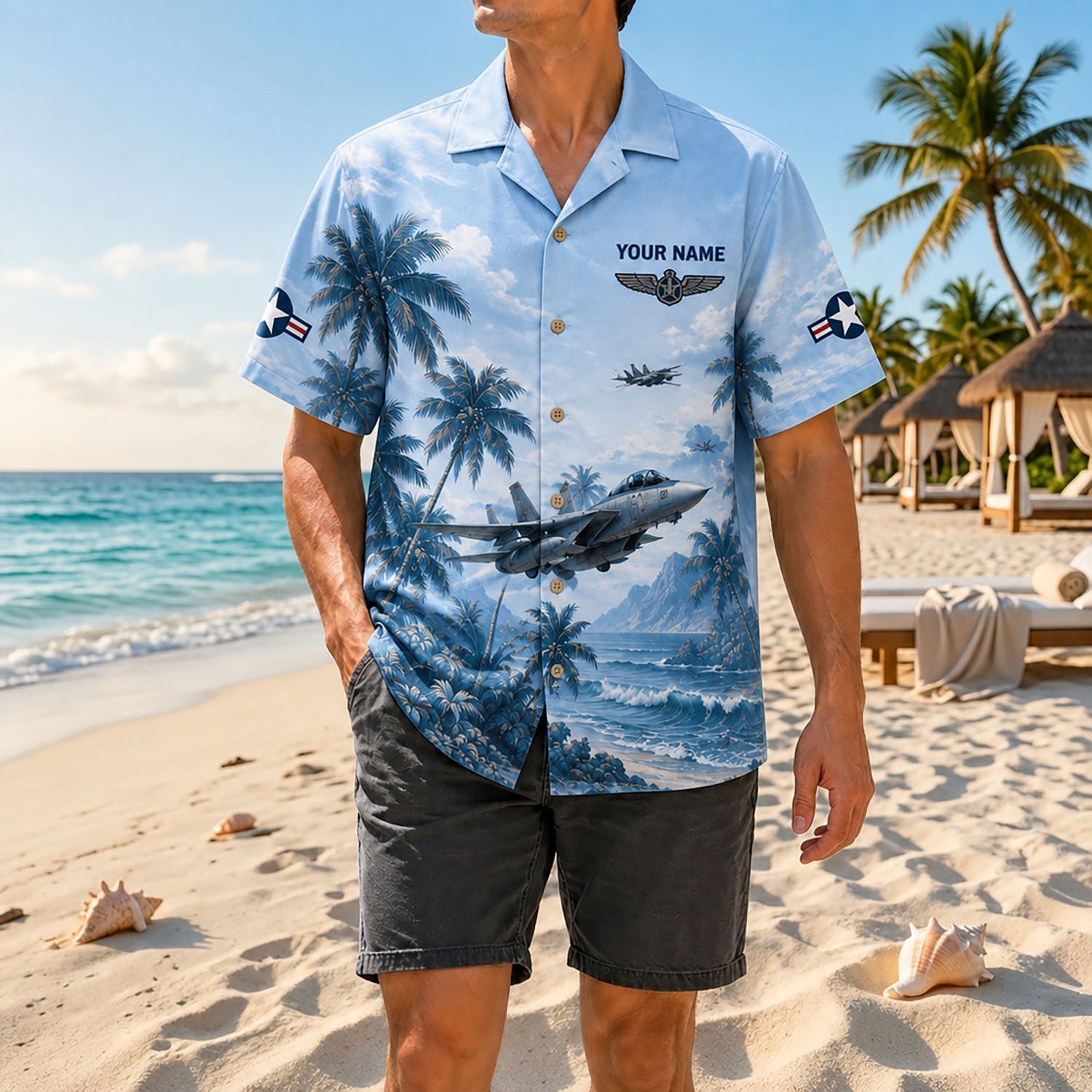 Full shot of a male model standing on the sand wearing the custom name F-14 Tomcat fighter jet shirt with casual charcoal shorts