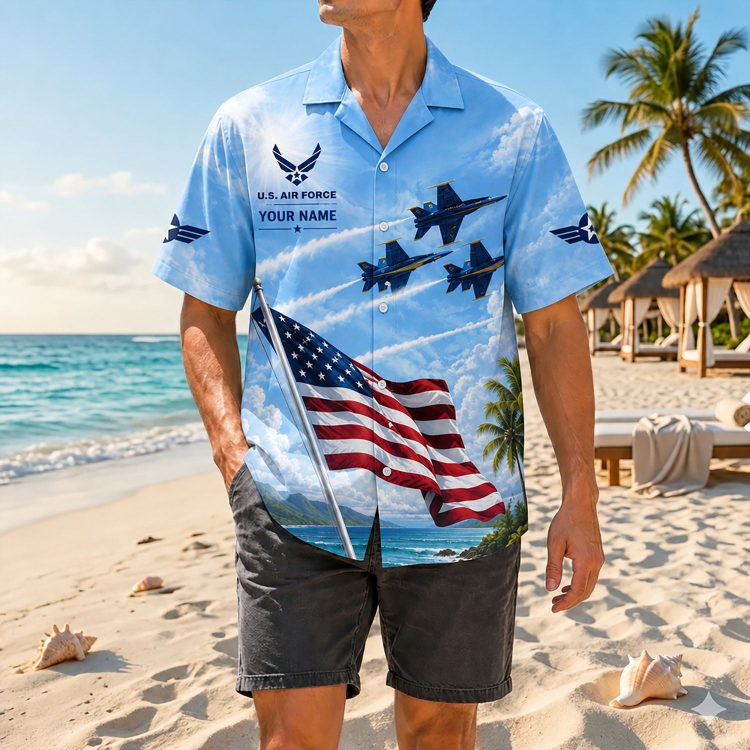 Full-body shot of a man on a sandy shore wearing the customized military jet airshow shirt paired with dark grey summer shorts