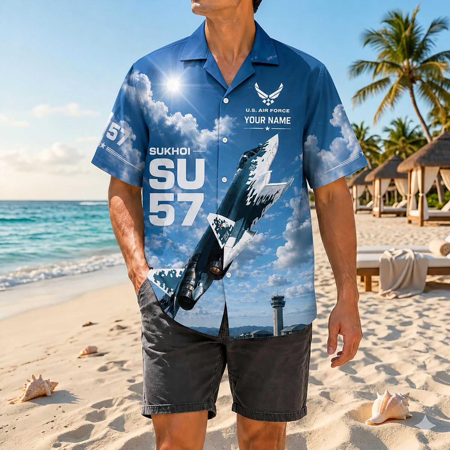 Full shot of a male model standing on the sand wearing the custom name Su-57 jet veteran shirt with dark casual shorts