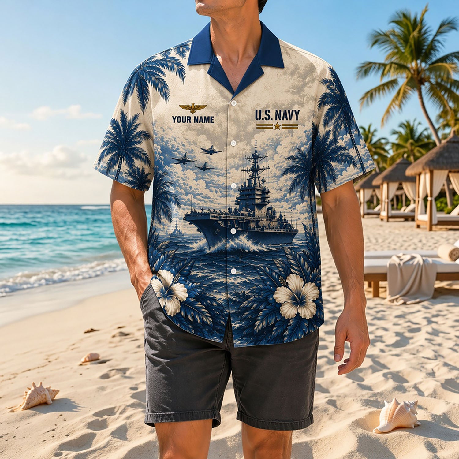 Full shot of a male model standing on sand wearing the custom name navy flight wings shirt with a contrast navy collar and charcoal shorts