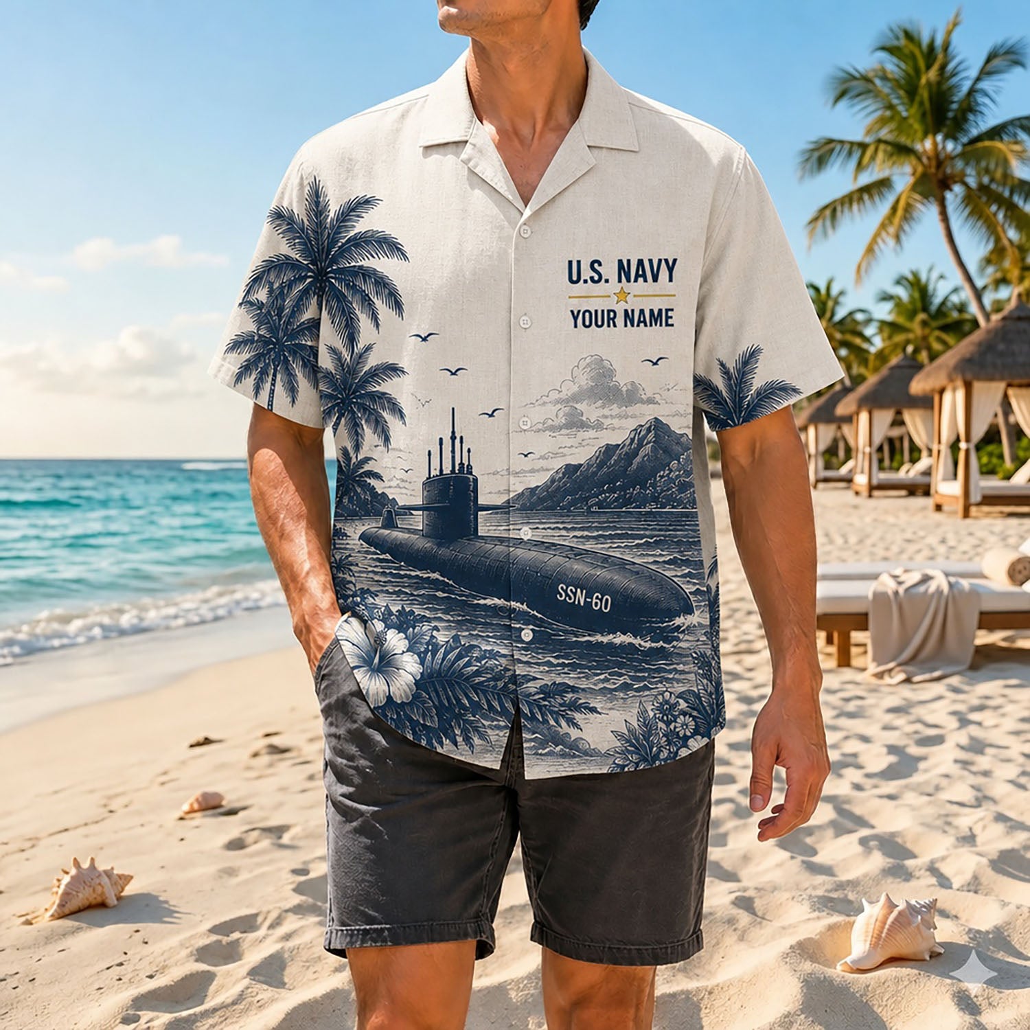 Full shot of a male model standing on sand wearing the custom name US Submarine Force shirt paired with dark casual shorts