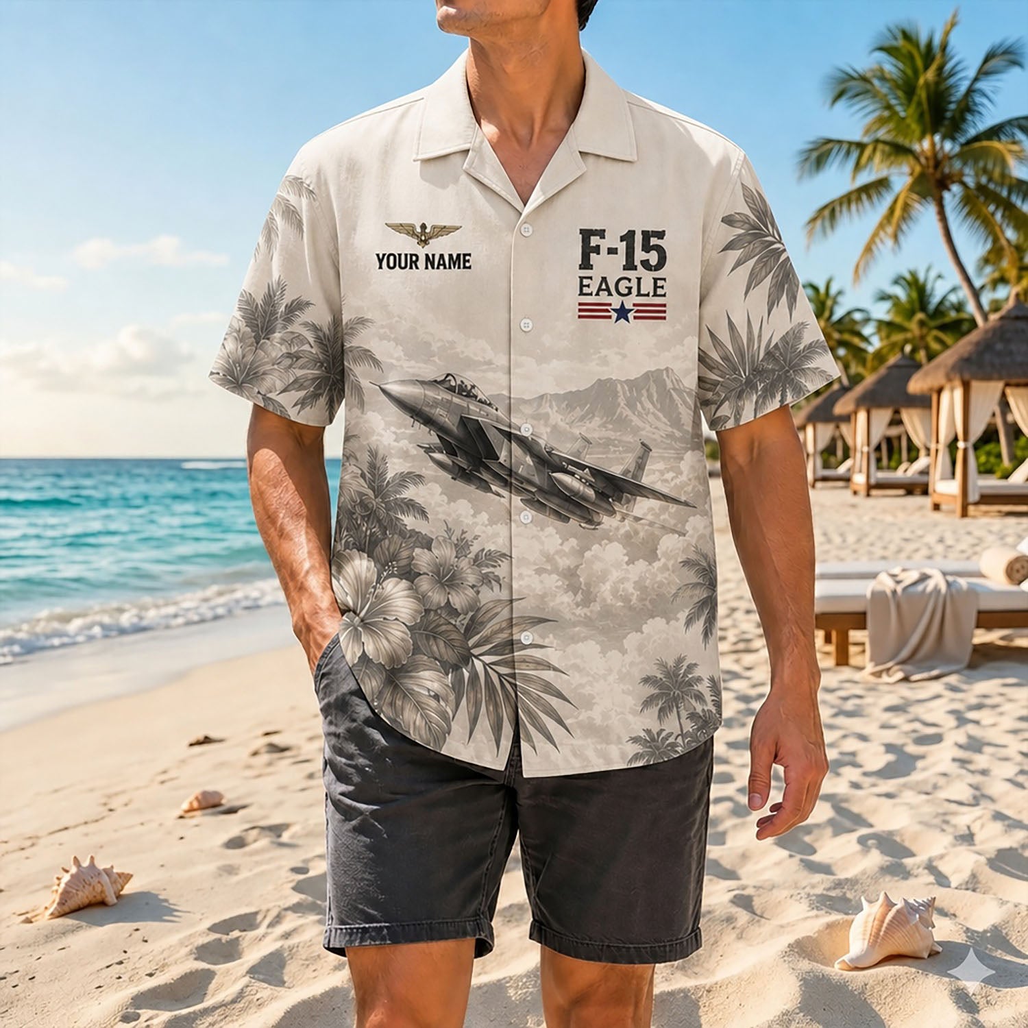Full shot of a male model standing on white sand wearing the custom name F-15 jet shirt paired with dark grey shorts