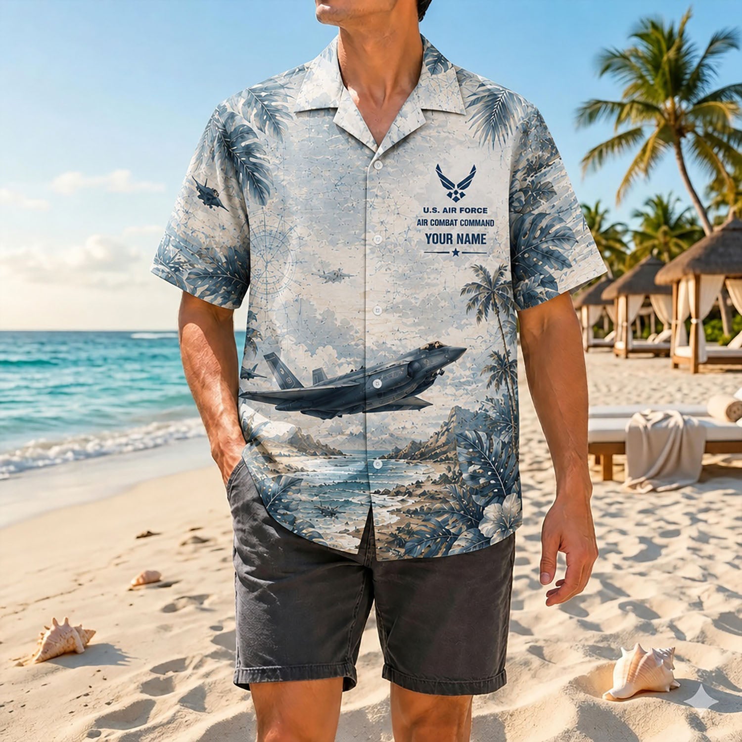 Full-body shot of a man modeling the custom military aviation shirt on a sandy coast paired with dark grey casual shorts