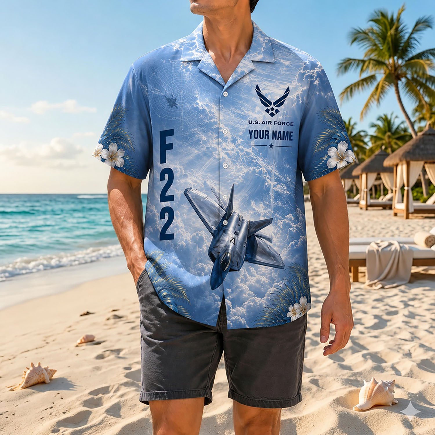 Full shot of a male model standing on a sunny beach wearing the custom name F-22 aviation shirt paired with dark casual shorts