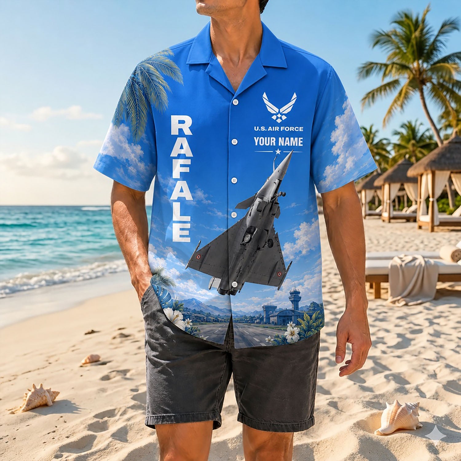 Full shot of a male model standing on a sunny coast wearing the custom name Rafale aviation shirt paired with dark casual shorts