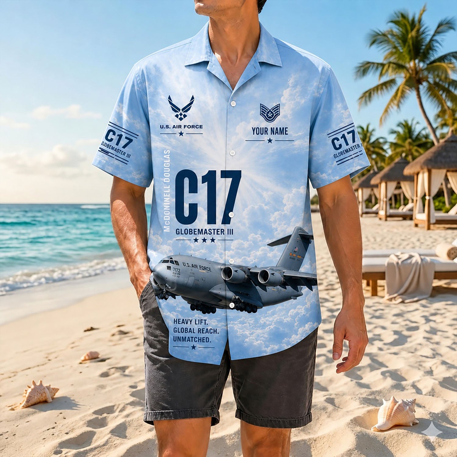Full shot of a male model standing on the sand wearing the custom name C-17 cargo jet veteran shirt with dark summer shorts