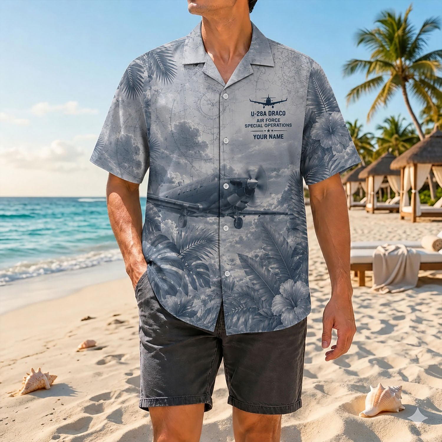 Full-body shot of a man modeling the vintage flight chart U-28A military plane shirt on a sandy coast paired with dark grey shorts
