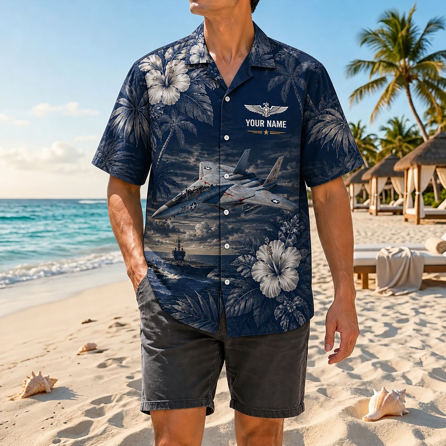 Full shot of a male model on the beach wearing the custom name F-14 jet shirt paired with charcoal grey shorts