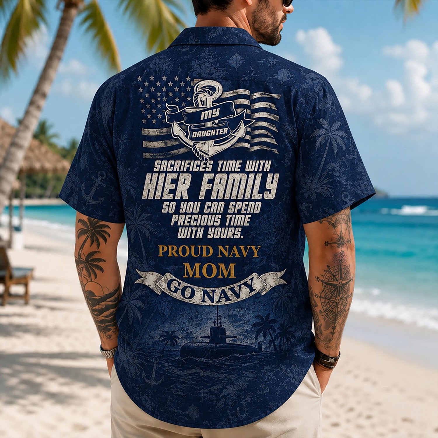 Back view lifestyle of a man on a beach wearing the personalized Navy Mom family support shirt with the large patriotic quote graphic