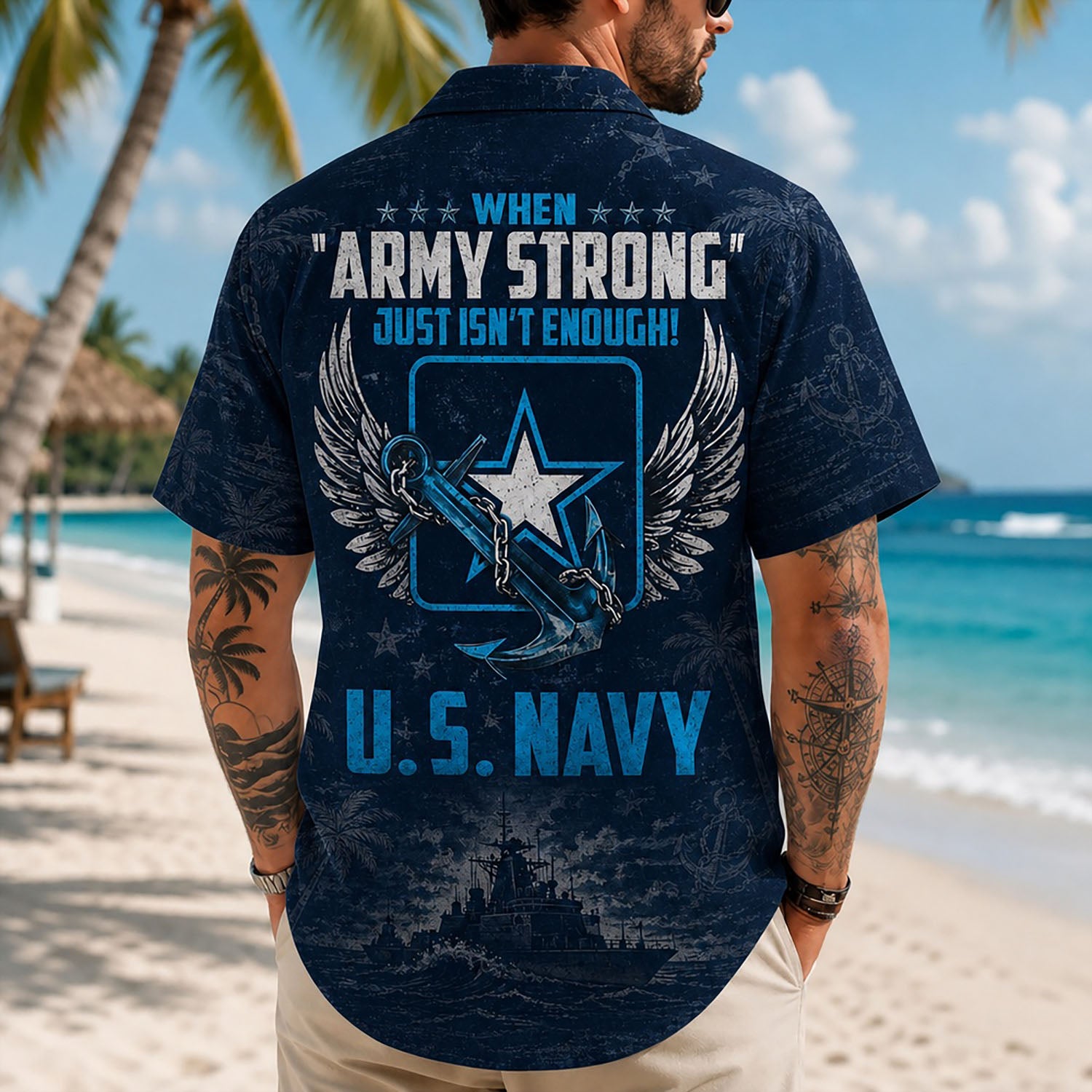 Back view lifestyle of a man on a beach displaying the detailed "U.S. NAVY" text, winged insignia, and ocean wave print