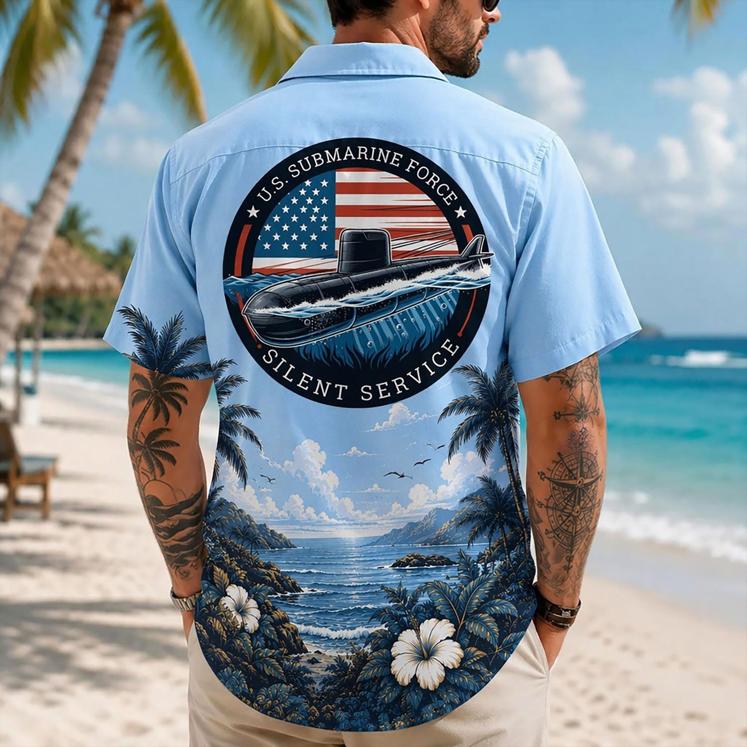 Back view lifestyle of a man on a beach wearing the custom submarine veteran shirt showing the large US Submarine Force Silent Service emblem print