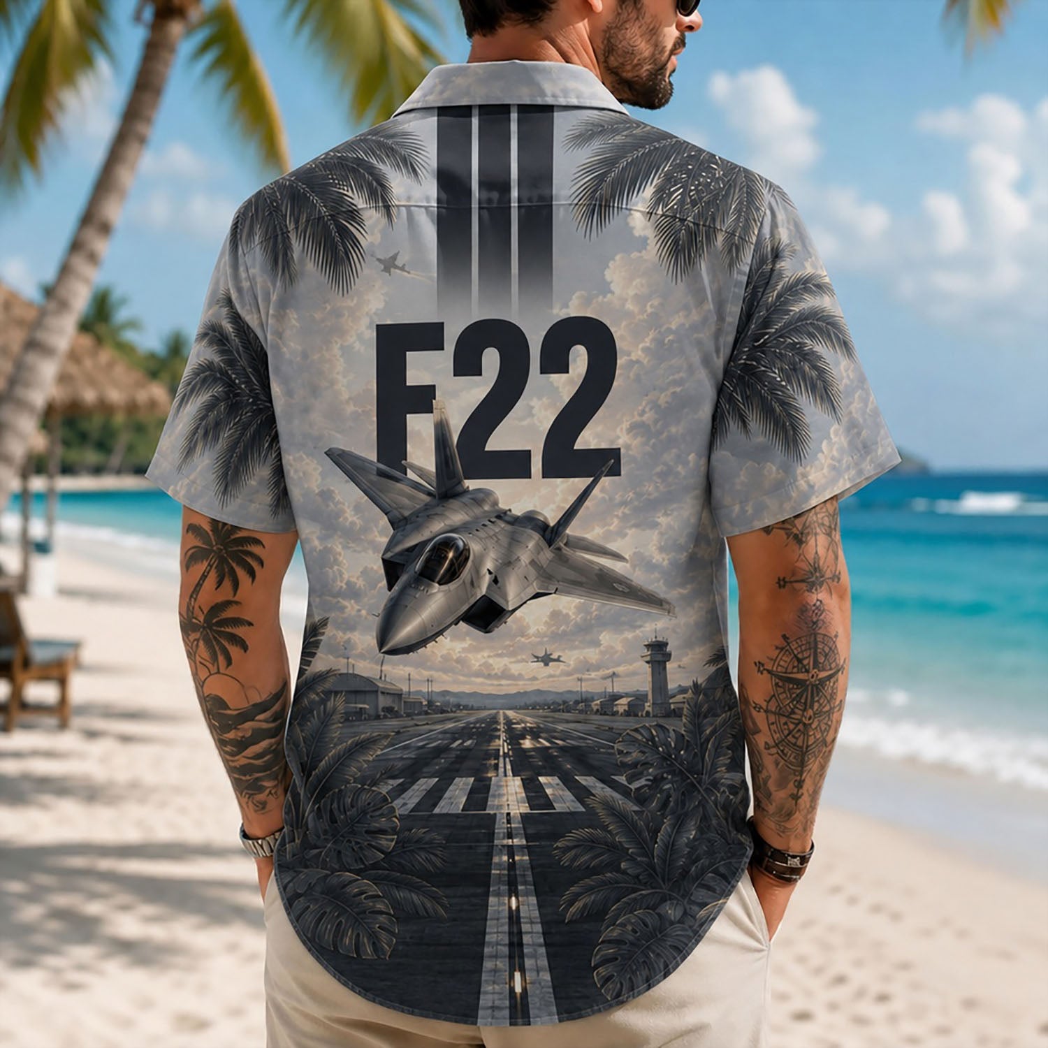 Back view lifestyle of a male model highlighting the ascending F-22 fighter jet artwork, tactical runway markings, and coastal palms backdrop