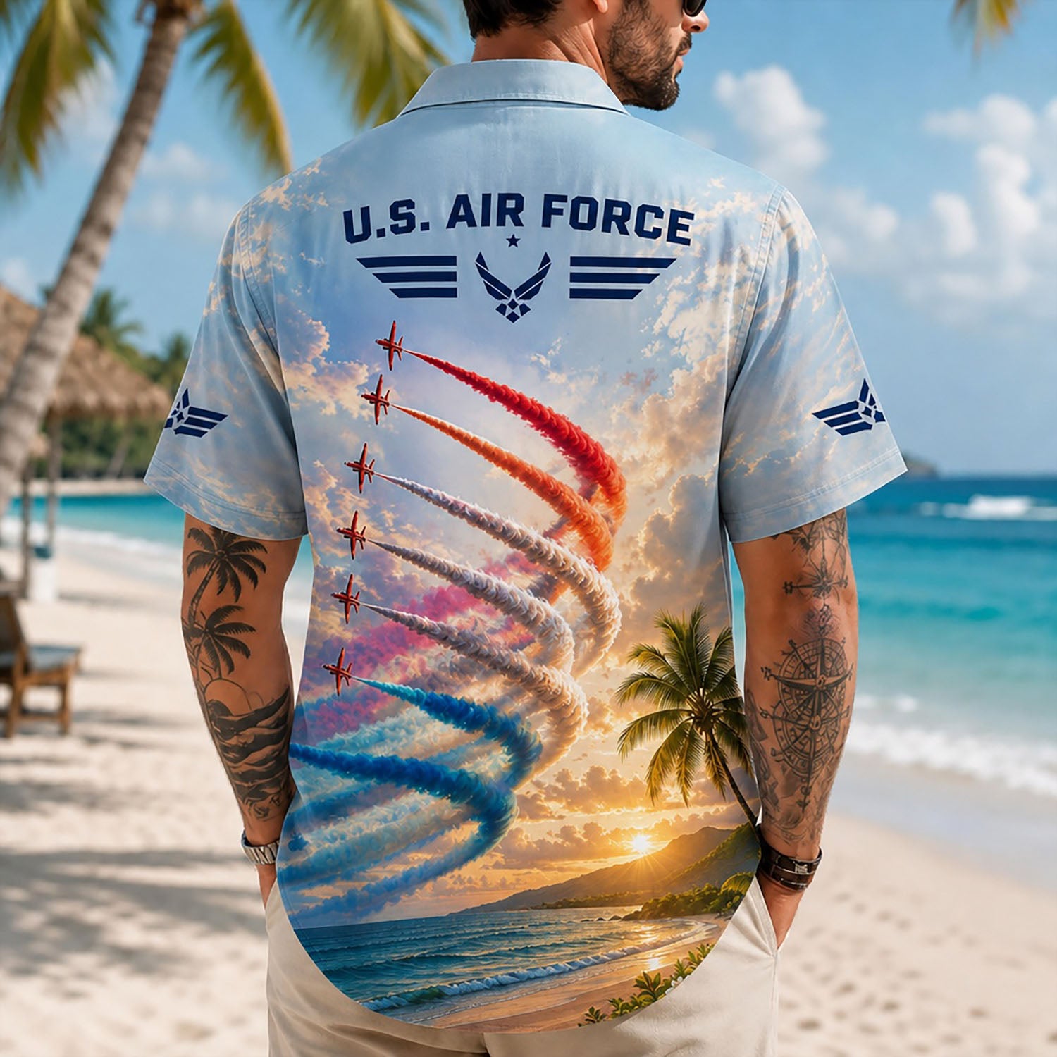 Back view lifestyle of a male model showing the dynamic loop-the-loop smoke trails, palm tree scenery, and airforce wing insignias on the sleeves