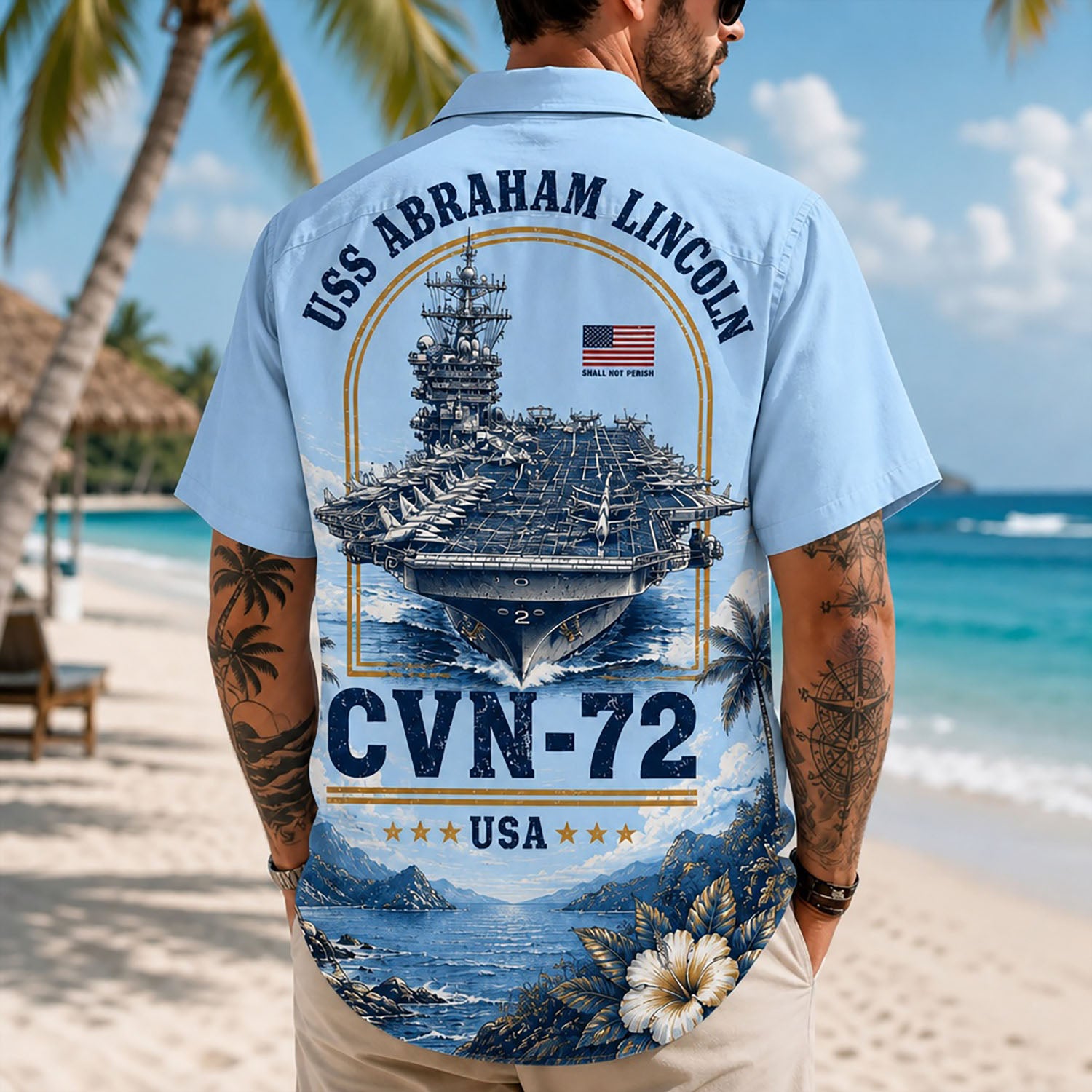 Back view lifestyle of a man on a beach wearing the custom veteran shirt showing the large USS Abraham Lincoln CVN-72 emblem print