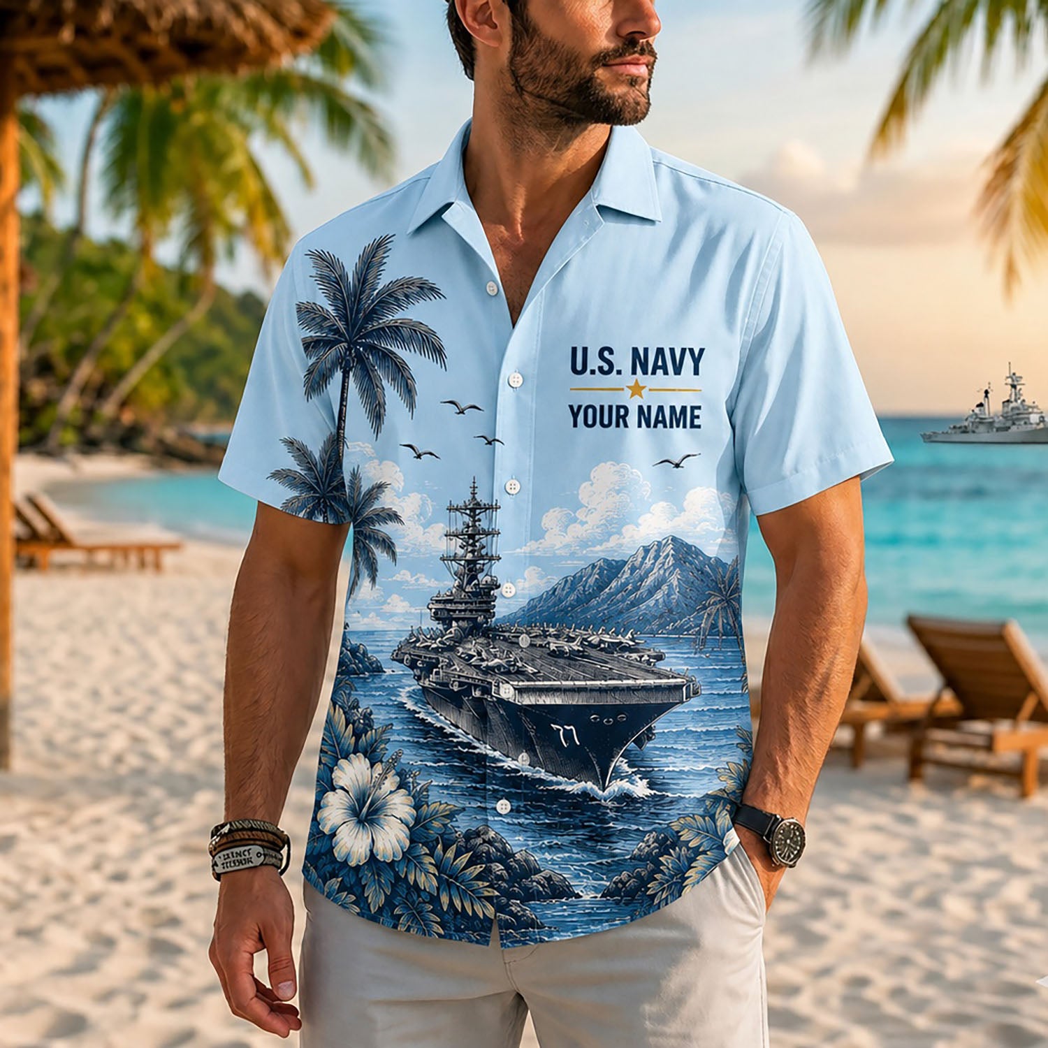 Close-up front view of a male model standing on a tropical beach wearing the personalized light blue USS George H.W. Bush military Hawaiian shirt