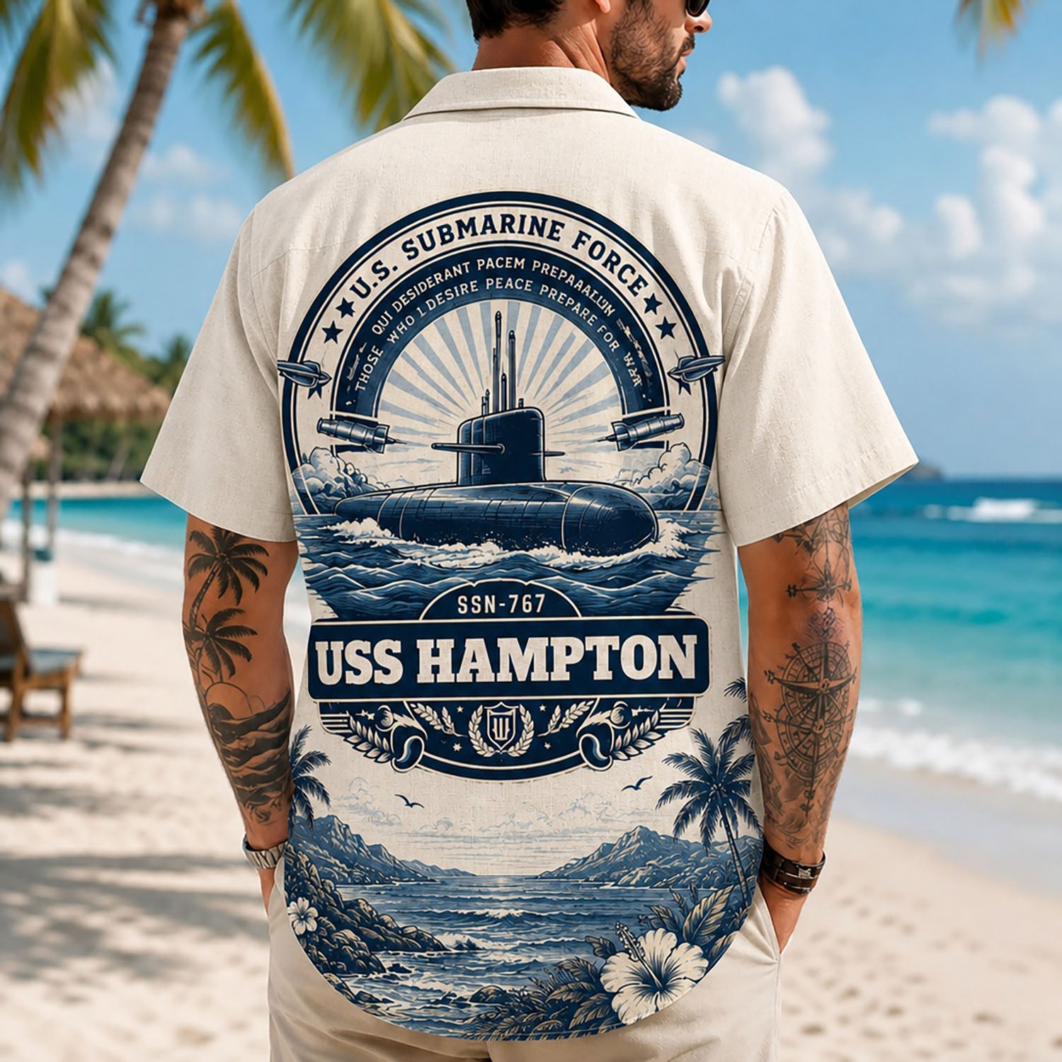 Back view lifestyle of a man on a beach wearing the custom veteran shirt showing the detailed USS Hampton SSN-767 emblem print