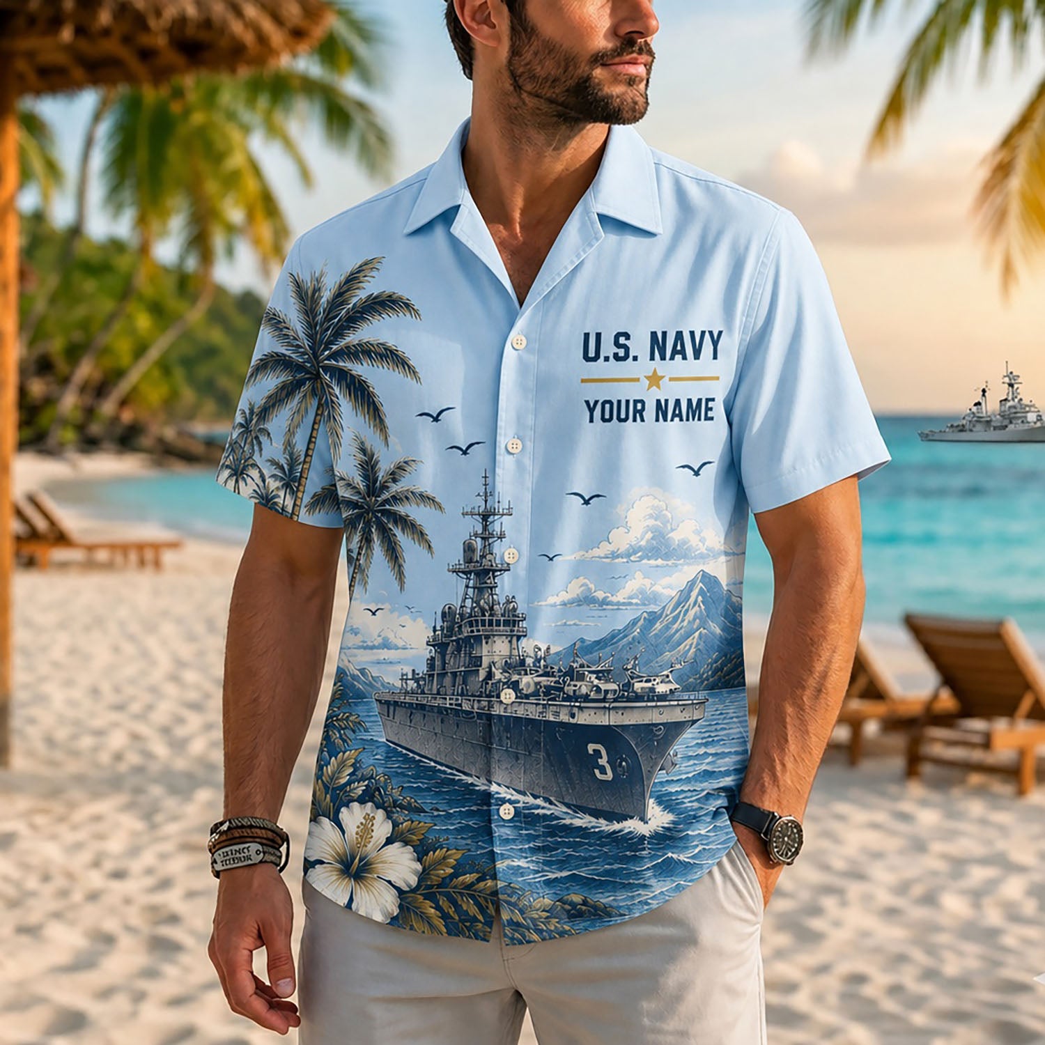 A male model wearing the custom USS Kearsarge LHD-3 US Navy Hawaiian shirt facing forward on a sunny tropical beach background
