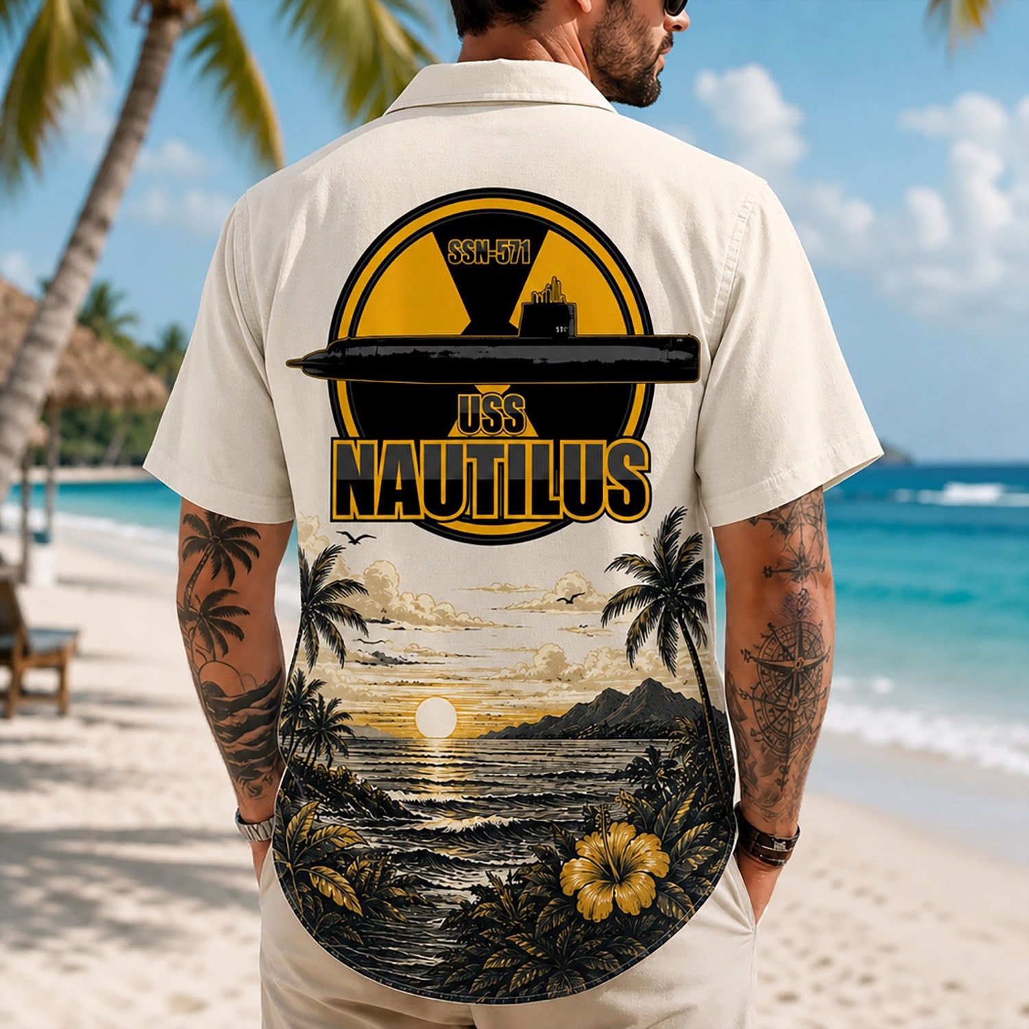 Back view lifestyle of a man on a beach wearing the custom veteran shirt showing the large USS Nautilus SSN-571 nuclear symbol emblem print
