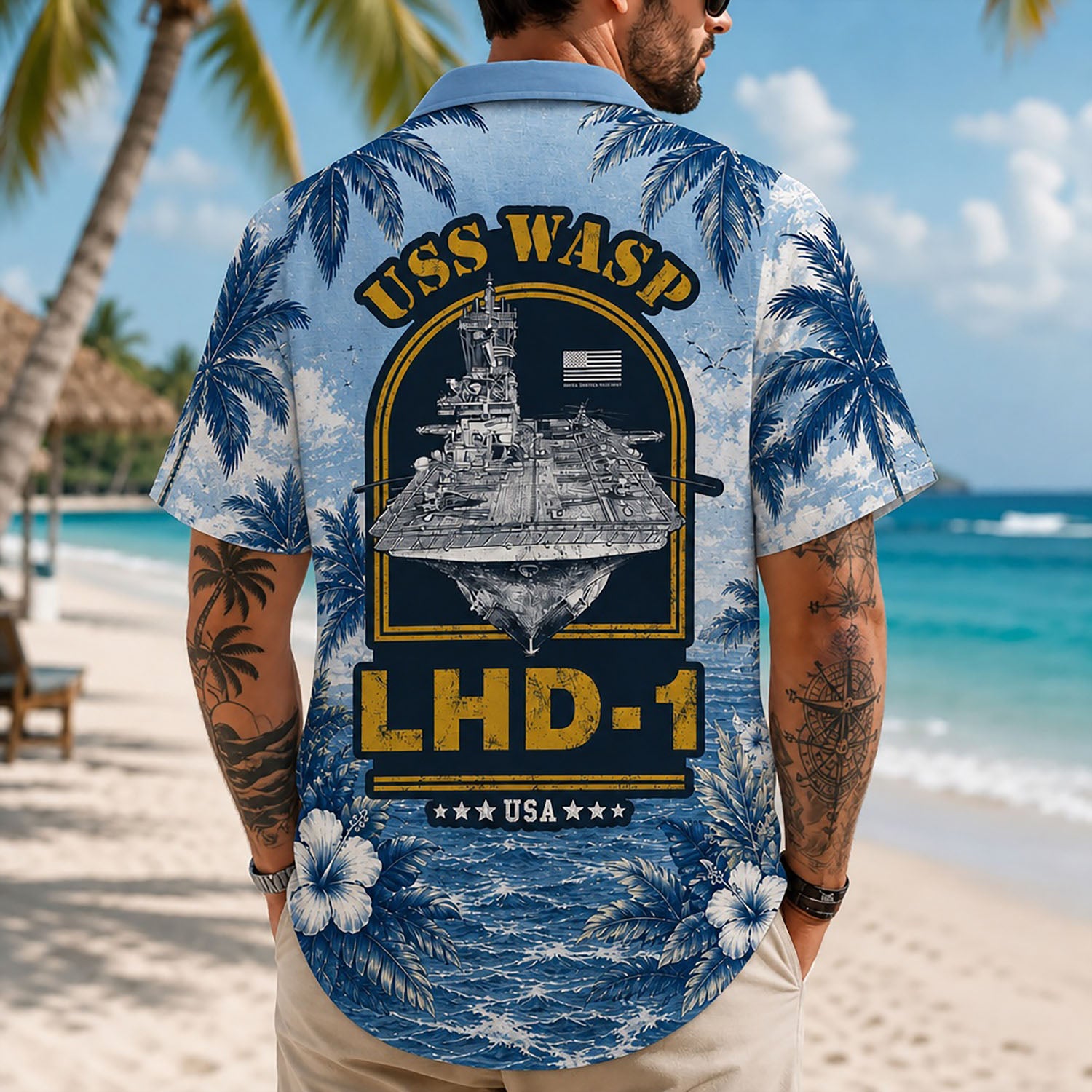 Back view lifestyle of a man on a beach wearing the custom veteran shirt showing the large USS Wasp LHD-1 ship emblem print