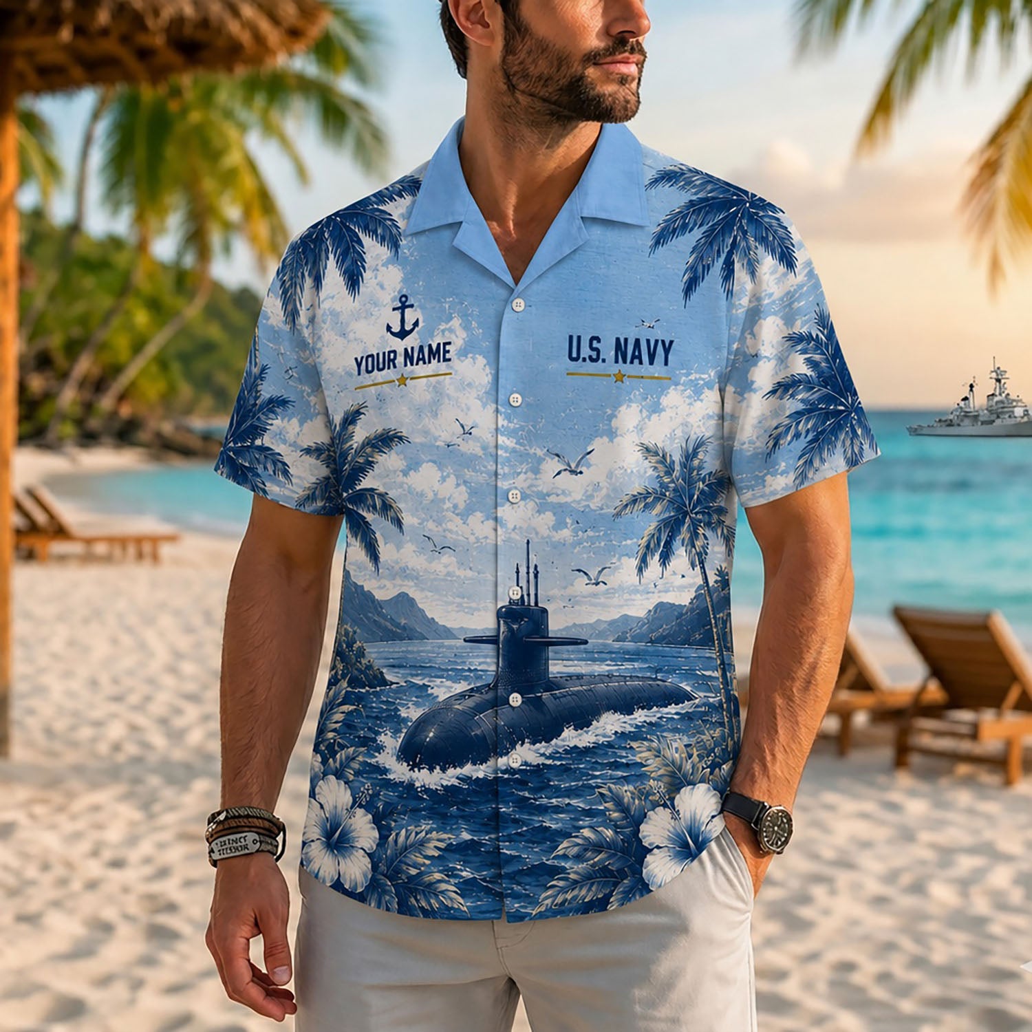 Close-up front view of a male model standing on a tropical beach wearing the personalized light blue USS Wasp LHD-1 military Hawaiian shirt