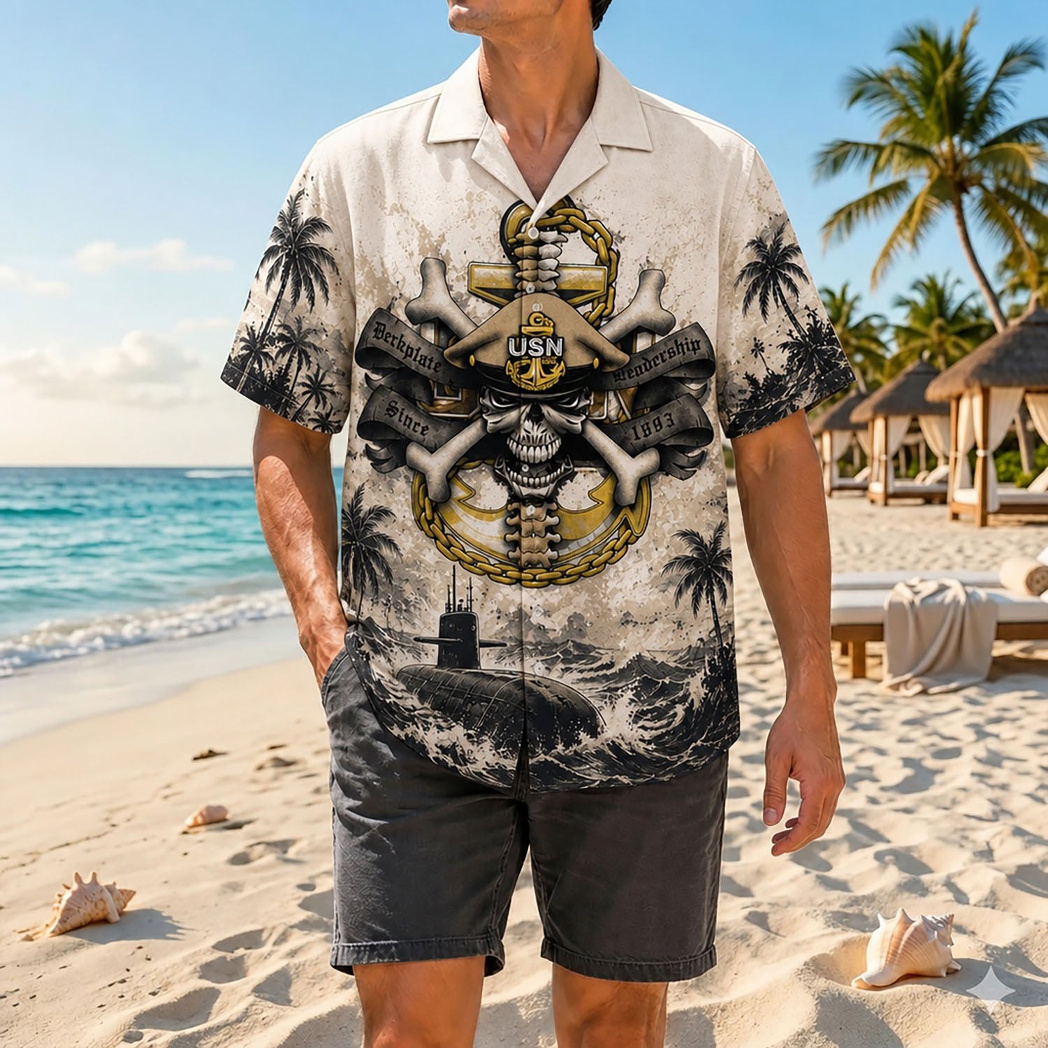 Full shot of a male model posing by the coastline wearing the personalized USN Chief skull military button-down with dark grey shorts