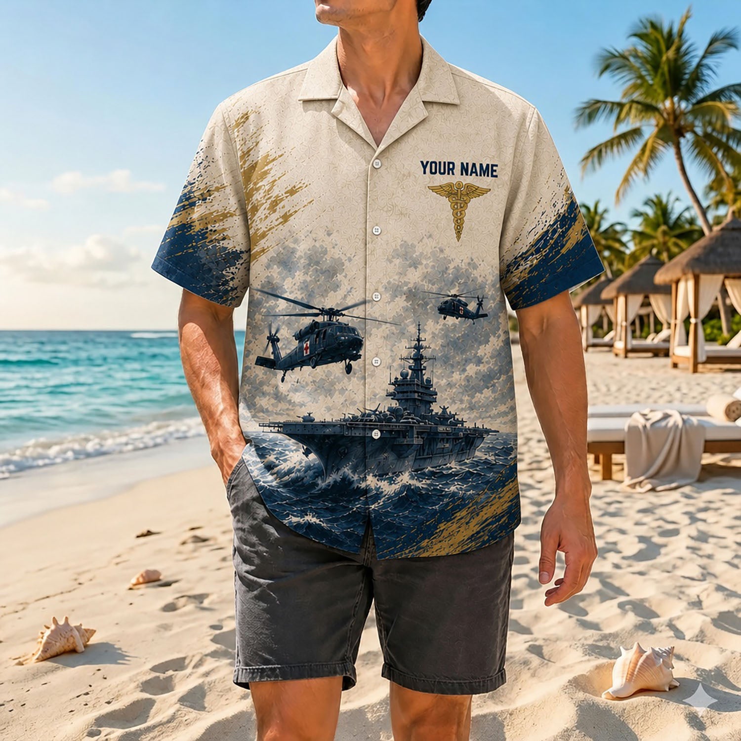 Full shot of a male model posing near the ocean wearing the custom Navy medical veteran shirt with charcoal grey beach shorts